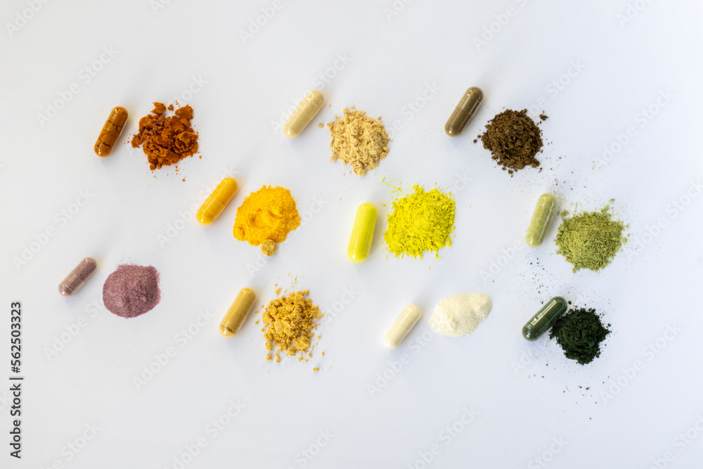 Opened and whole capsules of supplements on white background. Various