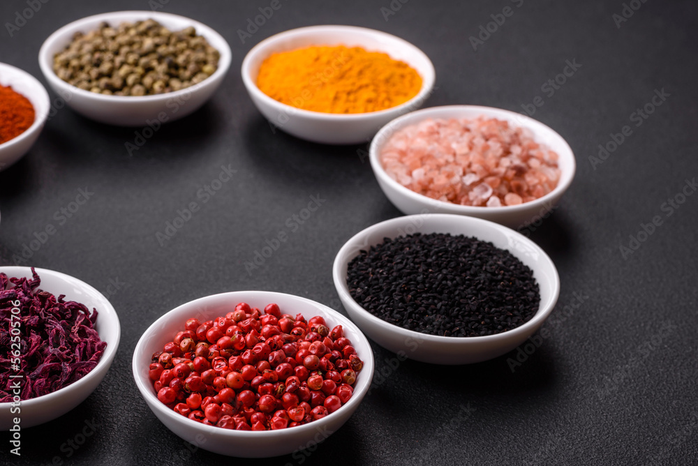 Composition consisting of a variation of several types of spices in white bowls