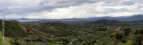 Panoramic View of Farm Fields and Town on the Sea Coast. Santa Maria Navarrese, Sardinia, Italy. Cloudy and Rainy Sky.