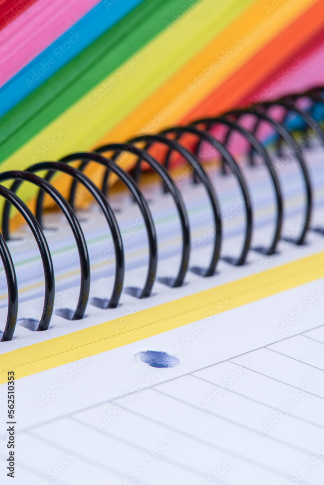 Colored of blank sticky note and lined notebook with wire binding, office supply close-up Colored of blank sticky note and lined notebook with wire binding, office supply close-up