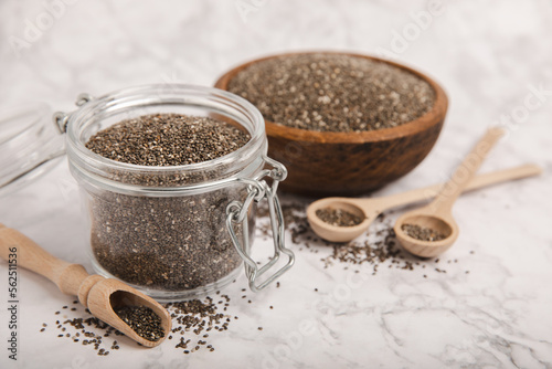 Chia seeds in a bowl and spoons on white marble. Superfood. Antioxidant. Healthy food. Proper nutrition. Diet concept. Place for text. Place to copy.