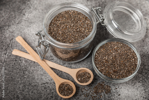 Chia seeds in a bowl and spoons on black marble. Superfood. Antioxidant. Healthy food. Proper nutrition. Diet concept. Place for text. Place to copy.