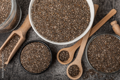 Chia seeds in a bowl and spoons on black marble. Superfood. Antioxidant. Healthy food. Proper nutrition. Diet concept. Place for text. Place to copy.