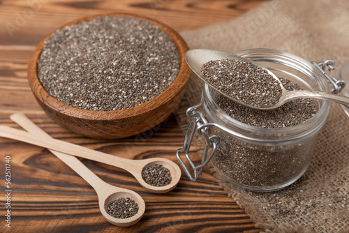 Chia seeds in jar and spoons on brown texture wood. Superfood. Antioxidant. Healthy food. Proper nutrition. Diet concept. Place for text. Place to copy. selective focus.