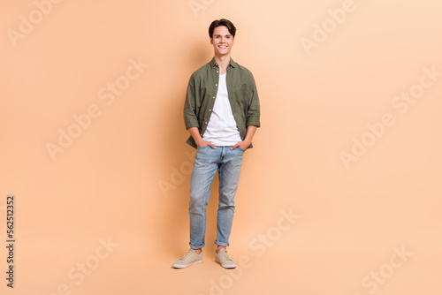 Full body length photo of young handsome attractive guy wearing new stylish clothes outfit promo poster advertise isolated on beige color background
