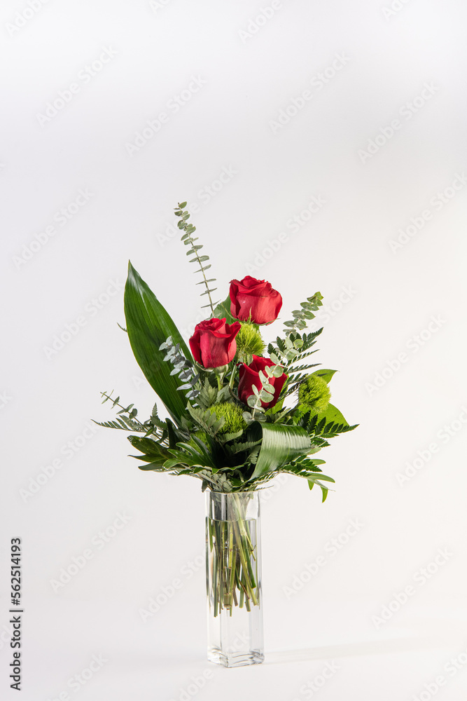 Red roses bouquet in a tall glass vase