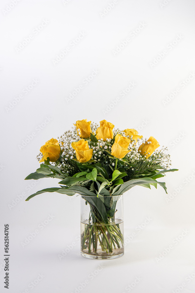 Bouquet of yellow roses in a glass container