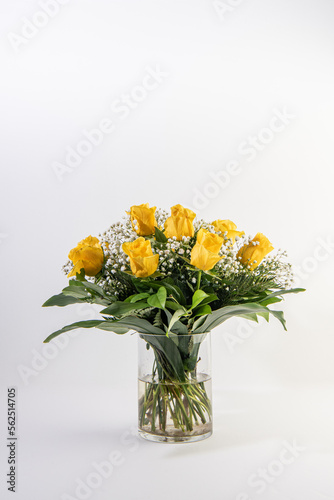 Bouquet of yellow roses in a glass container