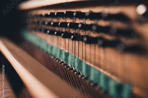 Old vintage acoustic piano inside with hammers and strings close up. Tuning musical instrument. Selective focus. photo
