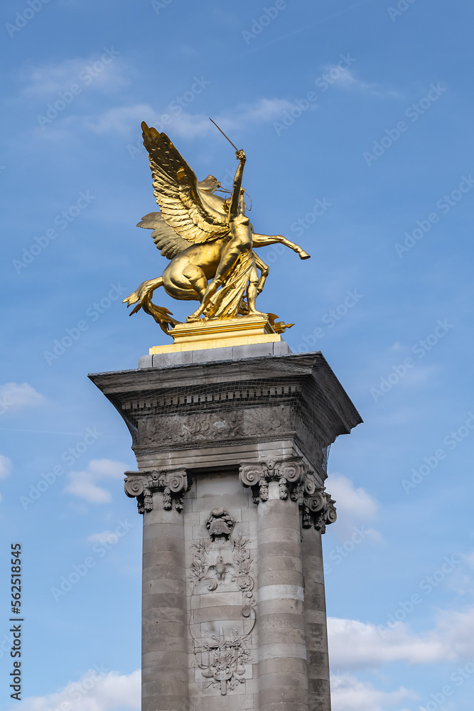 Fototapeta premium Pont Alexandre III (1896) - arch bridge spanning river Seine in Paris. Alexandre III bridge is most ornate, extravagant bridge in the city. Paris, France.