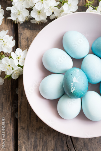 Blue Easter eggs with spring cherry blossom