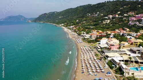 Agios Gordios exotic beach in Corfu island,Greece. Agios Gordios beach, Corfu island, Greece. Panoramic view of the Agios Gordios beach, sandy seashore with beach umbrellas and deck chairs. photo