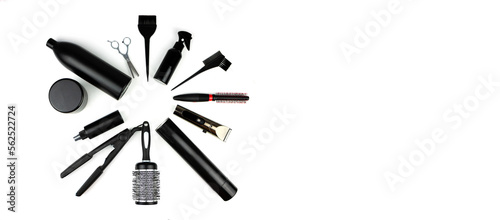 Professional hairdresser's accessories. A set of hairdressing combs and scissors in black color in a craft package on a white background.