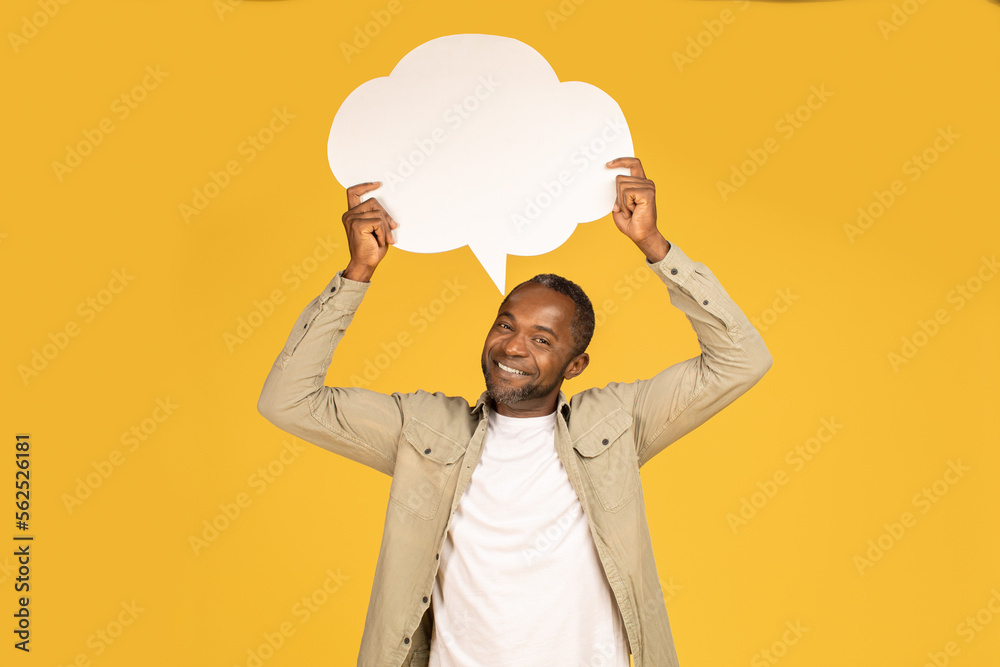 Cheerful middle aged african american male in casual hold abstract bubble, cloud with empty space Cheerful middle aged african american male in casual hold abstract bubble, cloud with empty space