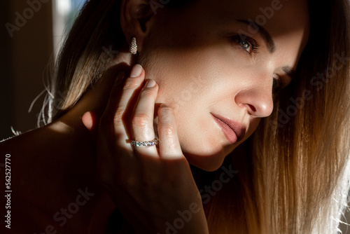 Fefashionable portrait of a girl in long diamond earrings.