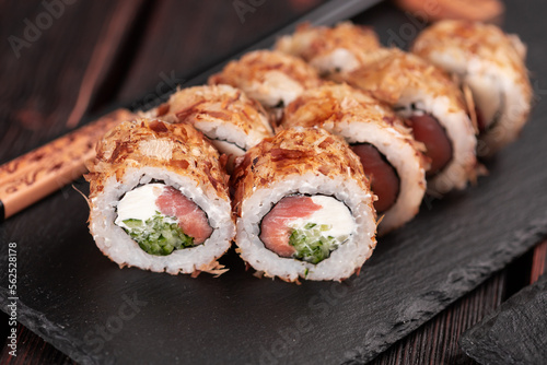 Salmon sushi roll with tuna flakes close-up - sushi asian menu and Japanese food