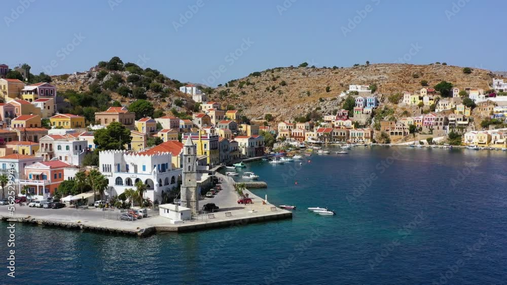 Aerial view of the beautiful greek island of Symi (Simi) with colourful houses and small boats. Greece, Symi island, view of the town of Symi (near Rhodes), Dodecanese. Aerial view of the beautiful greek island of Symi (Simi) with colourful houses and small boats. Greece, Symi island, view of the town of Symi (near Rhodes), Dodecanese.