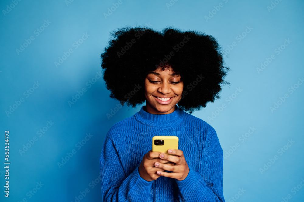 Cheerful black woman using smartphone Cheerful black woman using smartphone
