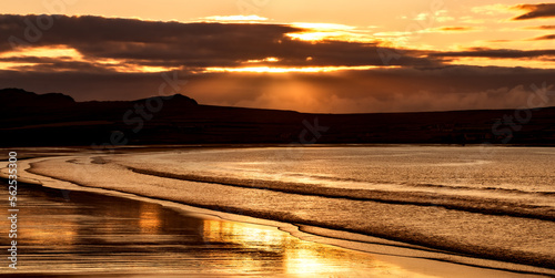 Golden sunset, Atlantic Ocean, mountains, beaches and beautiful cloudy skies this is the Dingle Peninsula on Ireland’s Wild Atlantic Way, southwest Atlantic coast photo