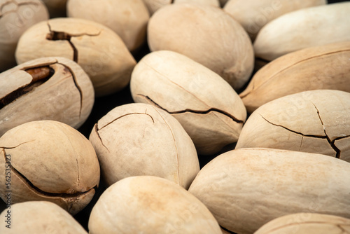 Close up Cracked pecans Nuts on black