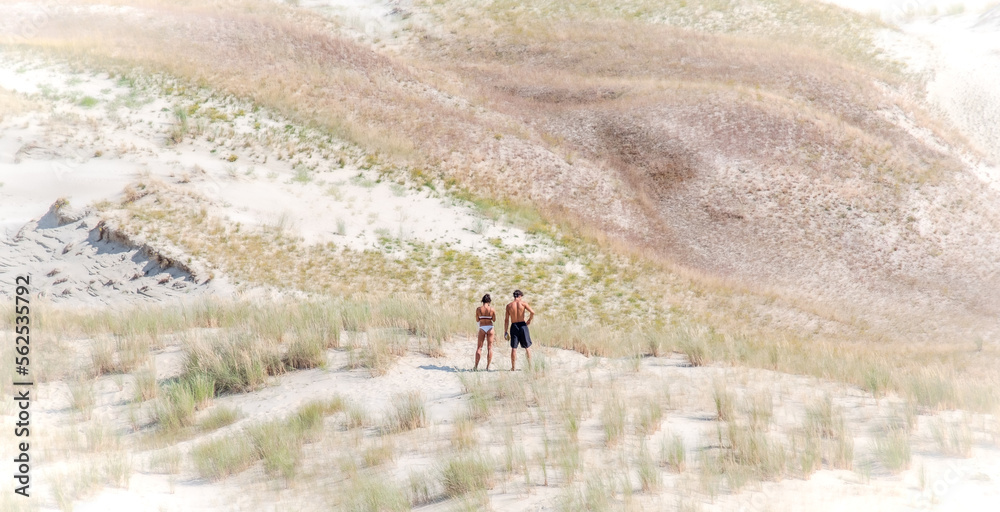 A young couple enjoying a holiday by the Baltic Sea at the sunny Golden Dunes in Nida, Lithuania
