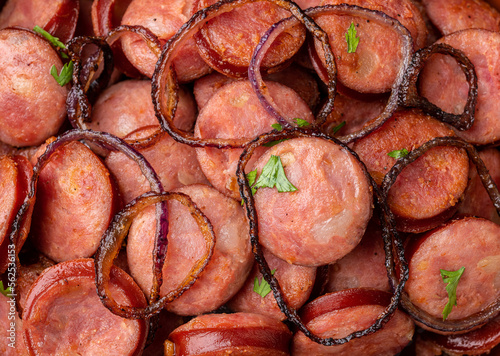 Closeup of grilled calabrese sausage portion with onion