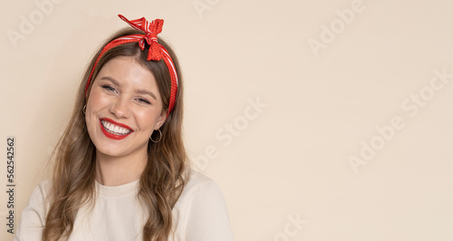 Crazy housewife with red lips and roller pin on isolated light brown background.