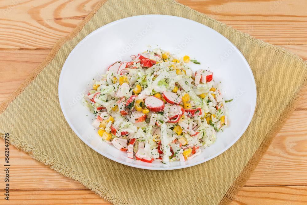 Salad of crab sticks and napa cabbage on rustic table Salad of crab sticks and napa cabbage on rustic table