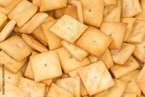 Heap of the salty crackers, top view close-up