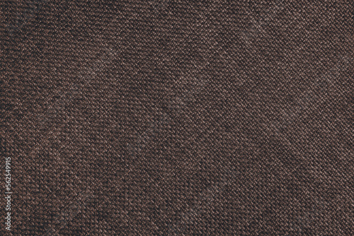 Jacquard woven upholstery, dark brown coarse fabric texture with diagonal weave lines. Textile background, furniture textile material, wallpaper, backdrop. Cloth structure close up.