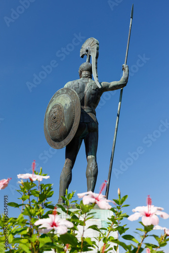 Statue of Achilles carrying a spear and shield in the garden of Achilleion on the Ionian island of Corfu, Greece. Shot from behind.