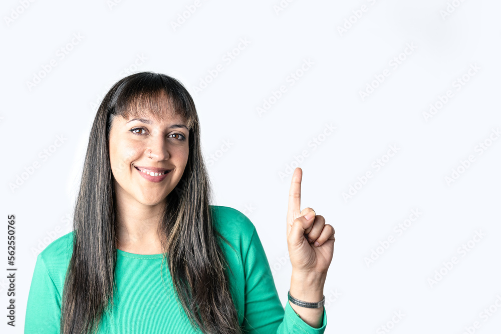 Young Latin American woman pointing up over white background with copy space for your text Young Latin American woman pointing up over white background with copy space for your text