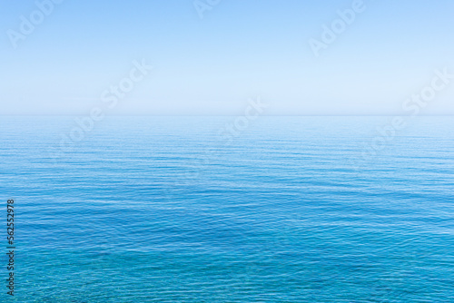 Ocean sky horizon line blends fading into infinity with blue turquoise colors of ocean waters and cloudless sky