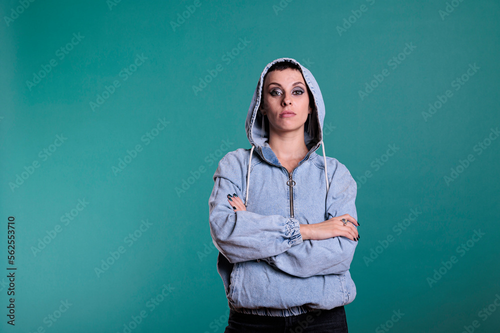Portrait of cheerful woman with gorgeous makeup and hoold on posing with confidence, standing over isolated background. Caucasian female feeling positive and confident looking at camera, indoors shot Portrait of cheerful woman with gorgeous makeup and hoold on posing with confidence, standing over isolated background. Caucasian female feeling positive and confident looking at camera, indoors shot