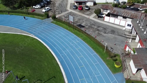 An athletic track and a stadium where athletes can train, between the hills, the woods and the city.