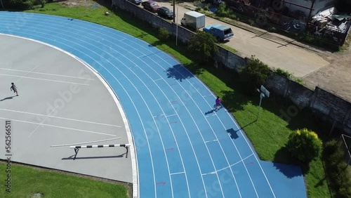 An athletic track and a stadium where athletes can train, between the hills, the woods and the city.