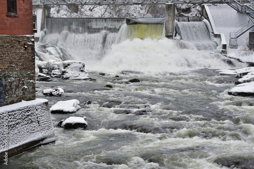 Magog river Sherbrooke Abenakis hydroelectric power plant dam. Cold winter day. photo