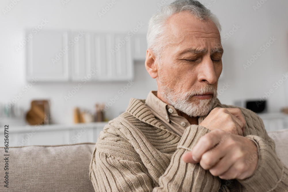 depressed senior man with parkinson disease sitting with closed eyes at home. depressed senior man with parkinson disease sitting with closed eyes at home.