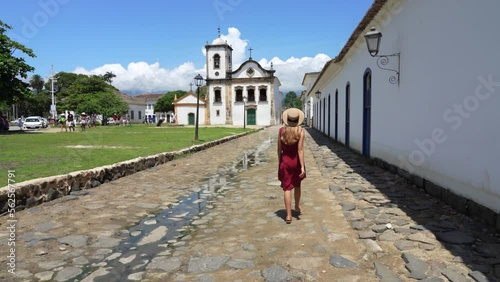 Beautiful young woman walking in the historic town of Paraty, UNESCO World Heritage Site, Rio de Janeiro, Brazil photo
