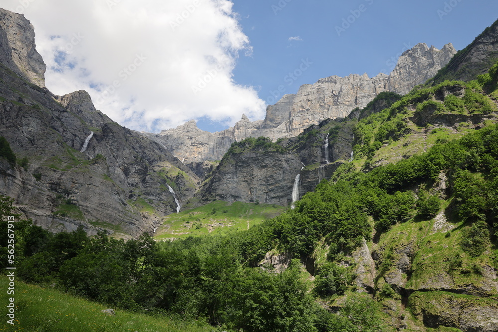 View on a waterfall in the Cirque du Fer-à-Cheval which is a natural circus of France located in the territory of the commune of Sixt-Fer-à-Cheval, in the department of Haute-Savoie