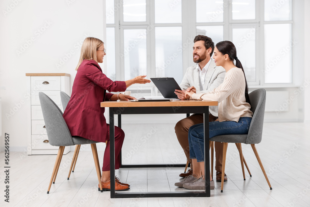 Real estate agent working with couple in new apartment Real estate agent working with couple in new apartment