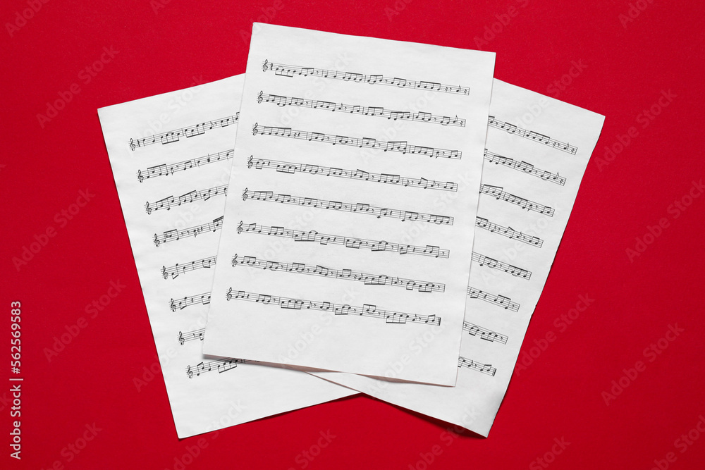 Note sheets on red background, flat lay Note sheets on red background, flat lay