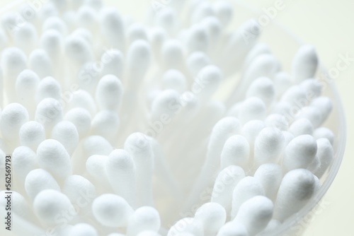 Many cotton buds in cup on white background, closeup