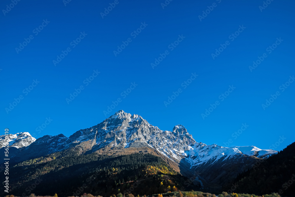 Picturesque view of beautiful high mountain under blue sky on sunny day