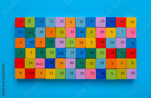 Wooden cubes with different numbers on light blue background  top view