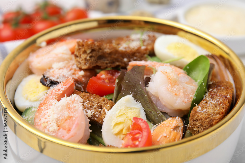 Delicious salad with croutons, tomatoes and shrimp served on table, closeup Delicious salad with croutons, tomatoes and shrimp served on table, closeup