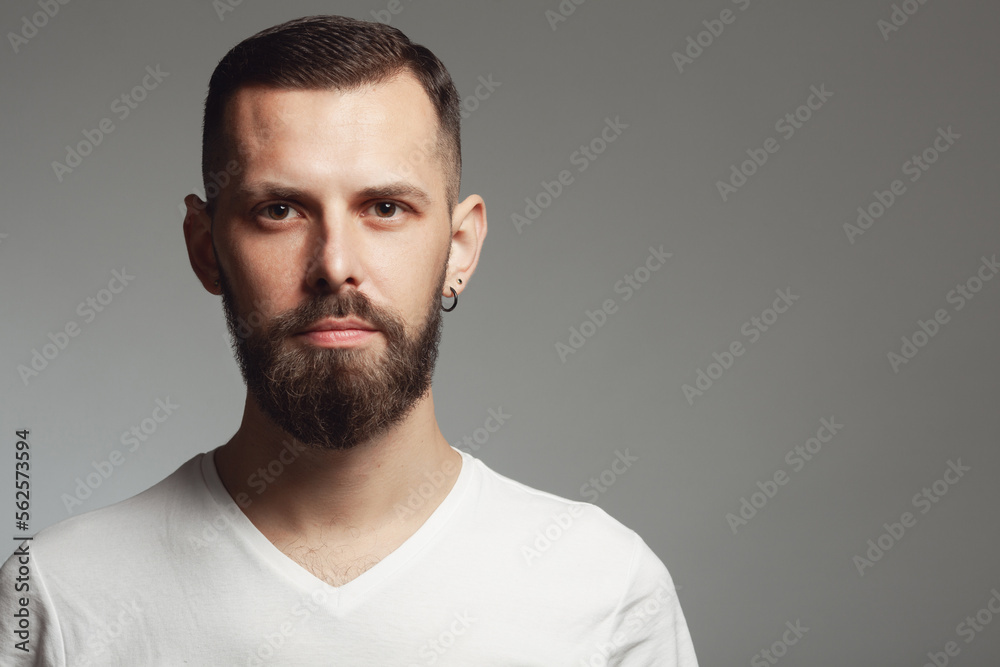Male beauty concept. Portrait of proud charismatic active 30-year-old man posing over gray background. Perfect haircut. Hipster style. Copy-space. Close up. Studio shot Male beauty concept. Portrait of proud charismatic active 30-year-old man posing over gray background. Perfect haircut. Hipster style. Copy-space. Close up. Studio shot