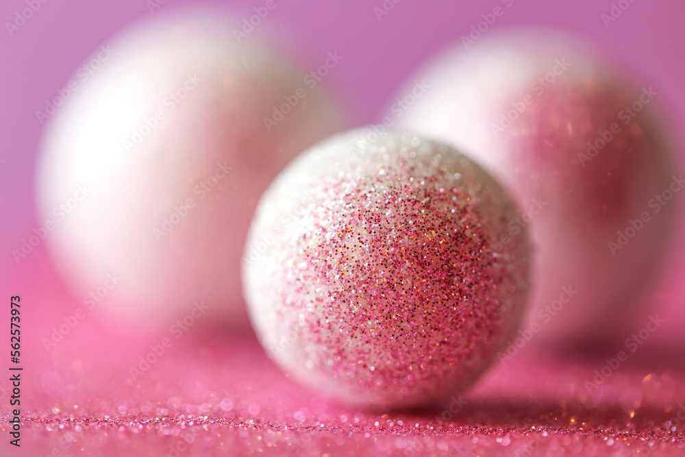 round balls and pink glitter.Abstract background in lilac and white colors with round balls.Shiny Festive Background.soft focus.