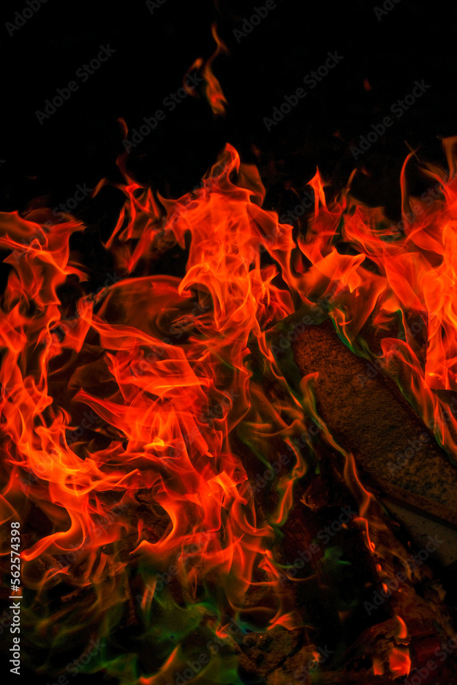 Multicolored flame.Firewood burning in bonfire.Burning bonfire.magical colorful flame. Sparks and flames.fiery wallpaper. Variegated flames and colorful sparks close-up. Multicolored flame.Firewood burning in bonfire.Burning bonfire.magical colorful flame. Sparks and flames.fiery wallpaper. Variegated flames and colorful sparks close-up.