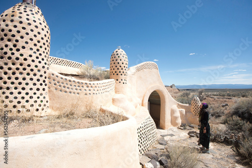 Young woman looking at architecture, Taos, New Mexico, USA photo